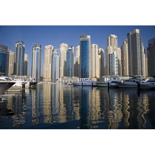 UAE, Dubai Marina towers with boats at anchor